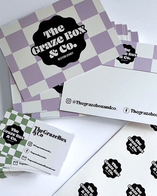 Graze Box & Co branding materials including a checkered box, business cards, and stickers on a white background.
