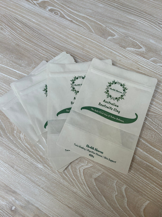 Health heiress product bags. White packets with green text and logo on a wooden surface